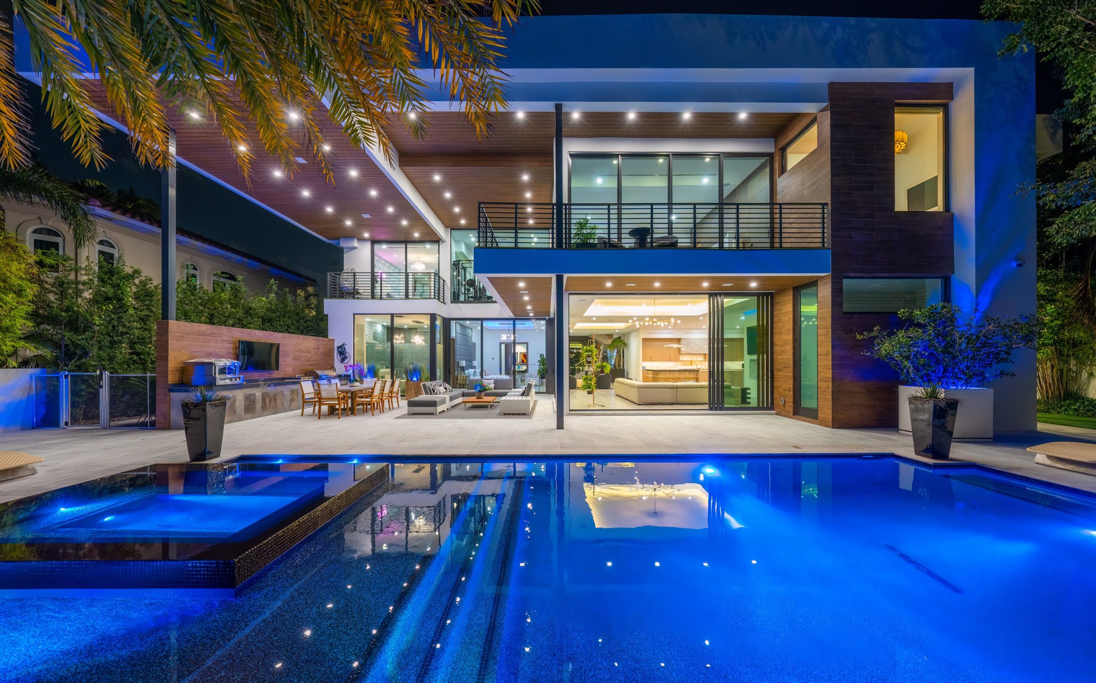 A modern estate and pool at night