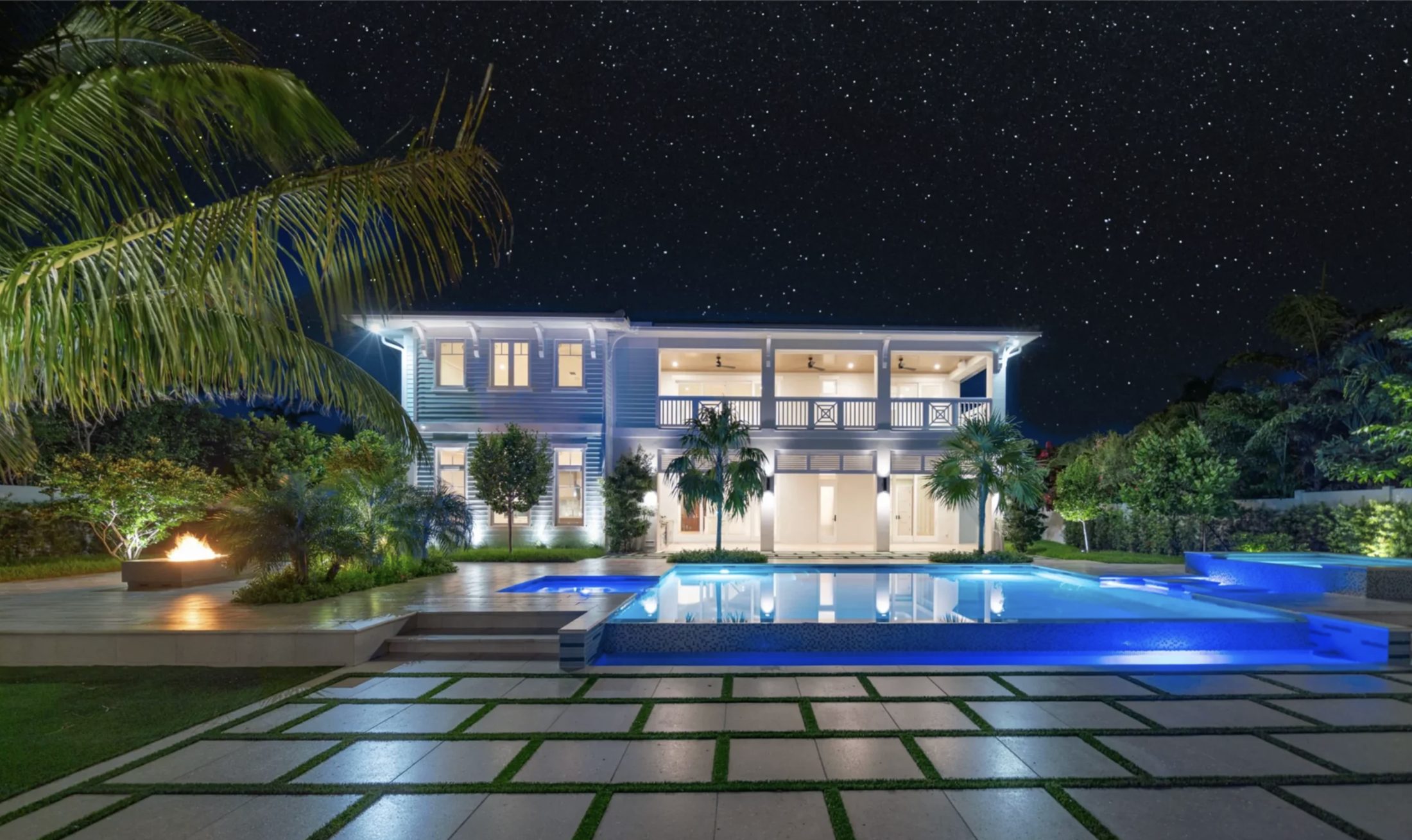 An estate and pool illuminated at night