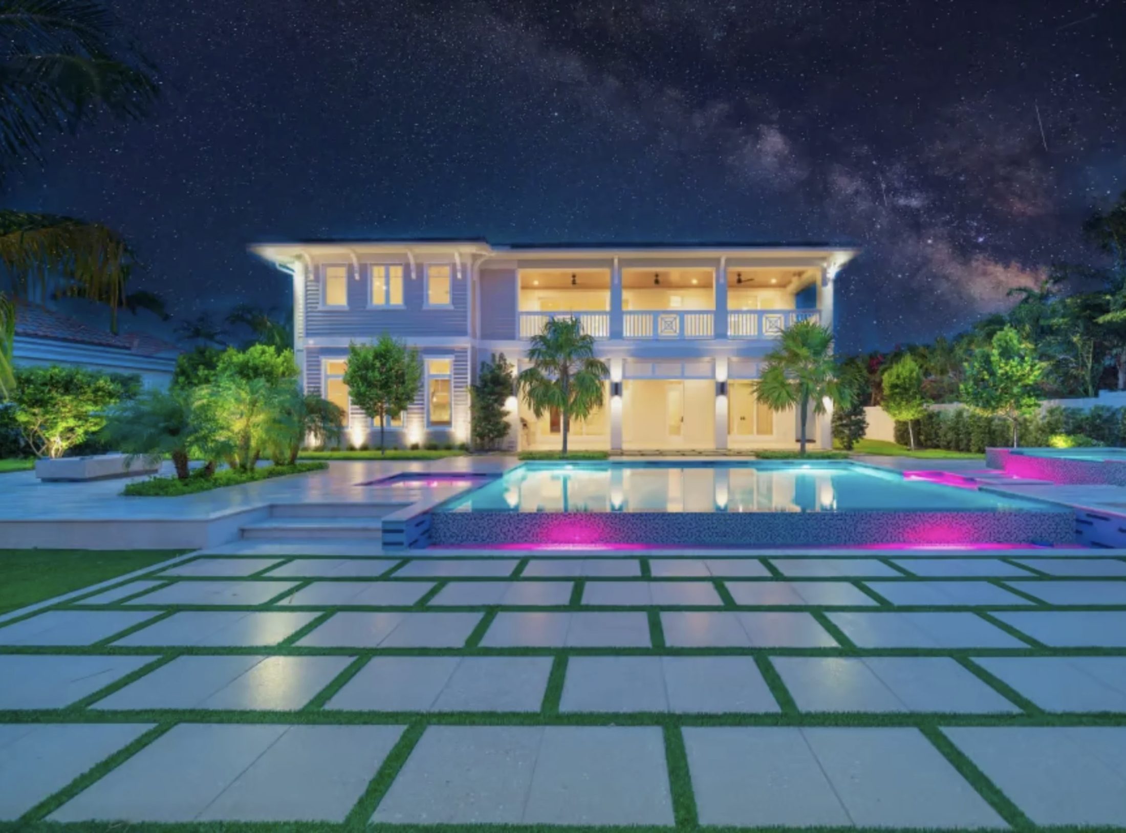 A modern estate and pool beneath a night sky
