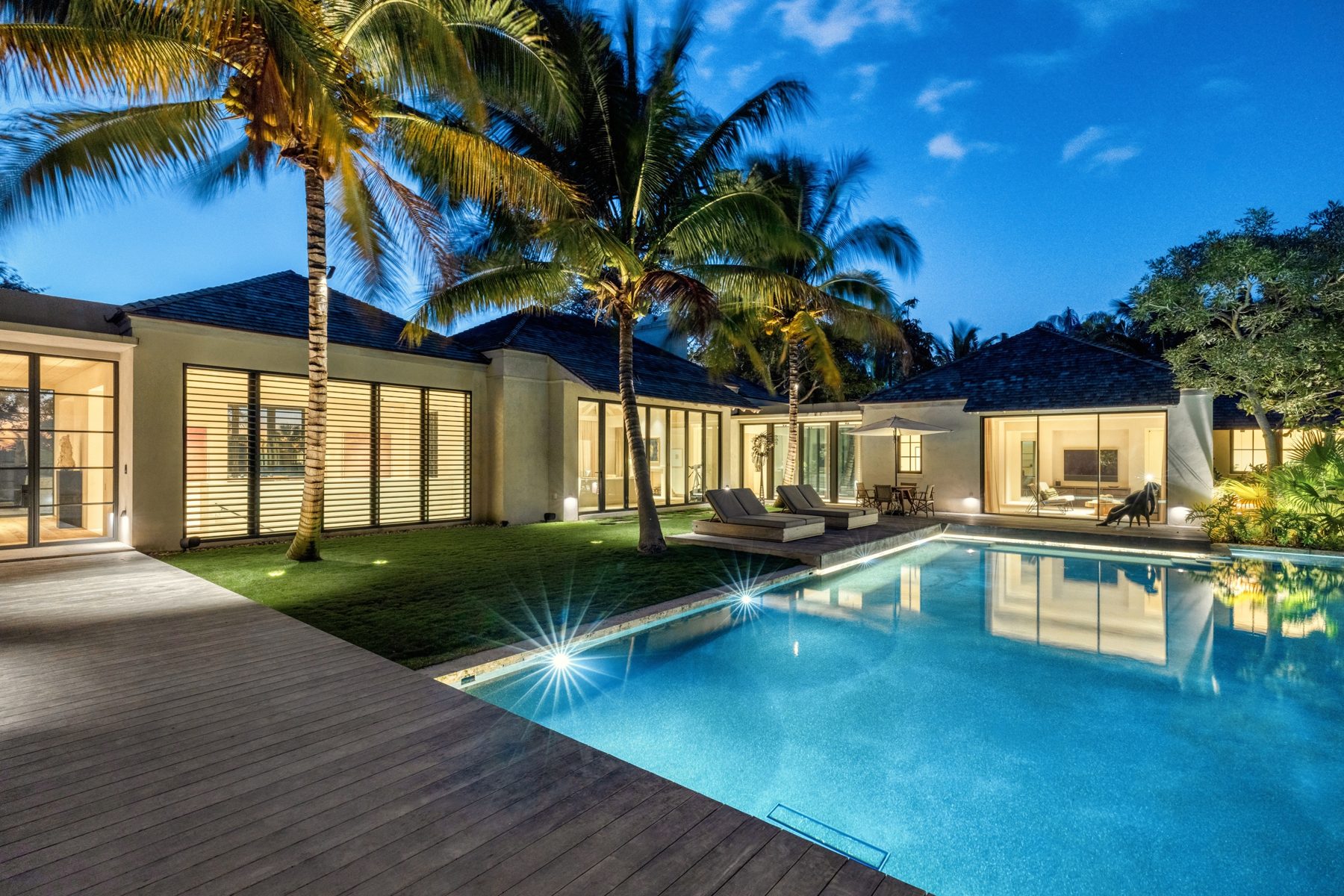 109 S River Road, Stuart, a modern home and pool at dusk