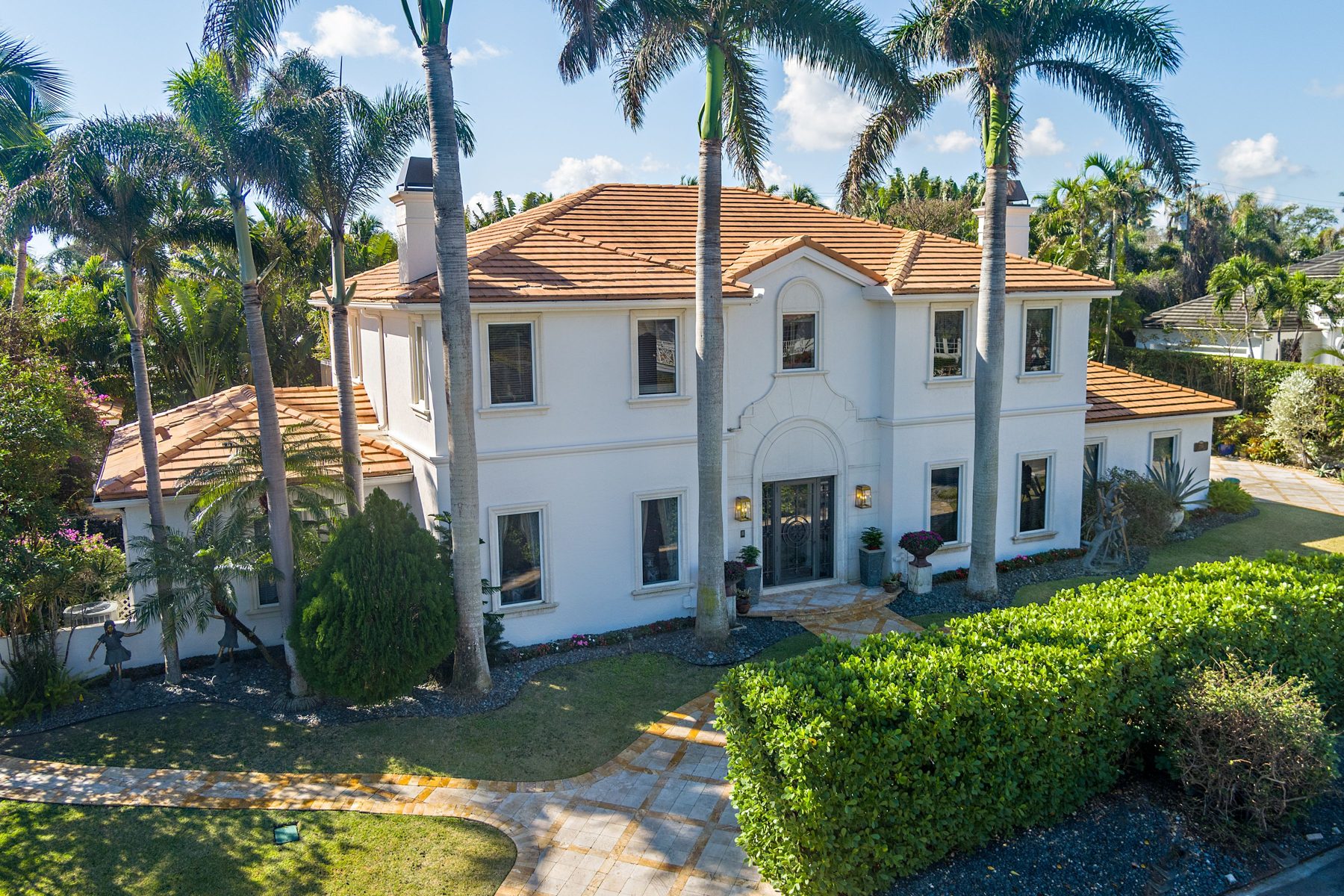 286 Jamaica Lane, Palm Beach, a white two story home framed by palms